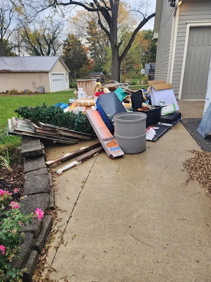Dumpster being loaded with debris for Estate Cleanout Dumpster Rental in Lindstrom